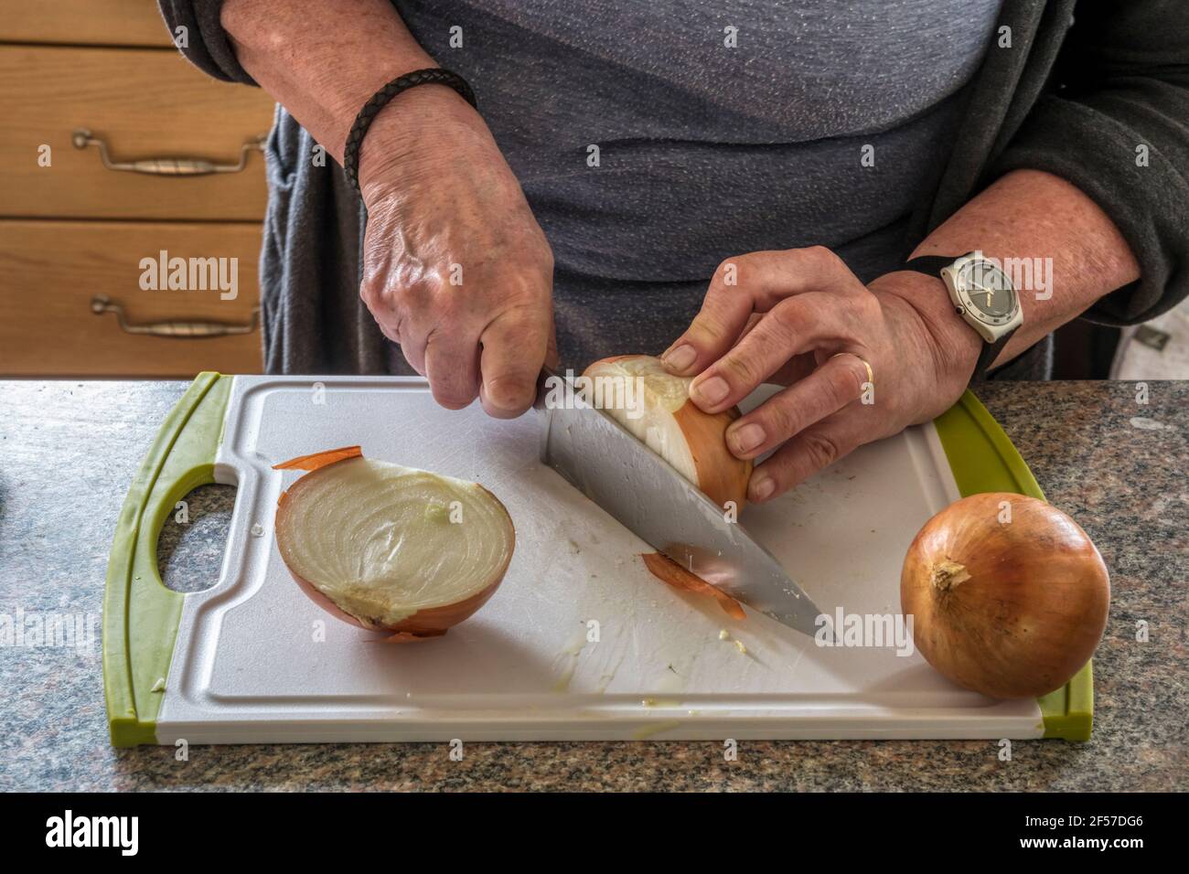 Woman chopping onions to make chutney. Stock Photo