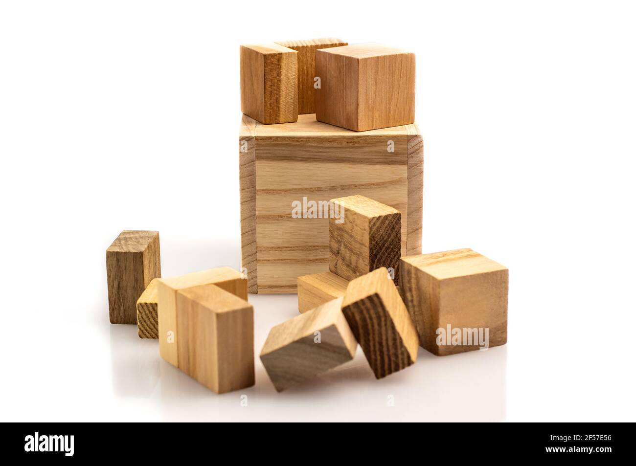 Wooden brain cube. Wooden puzzle made up of parts isolated on a white background. Business success concept. Layout for presentation. Stock Photo