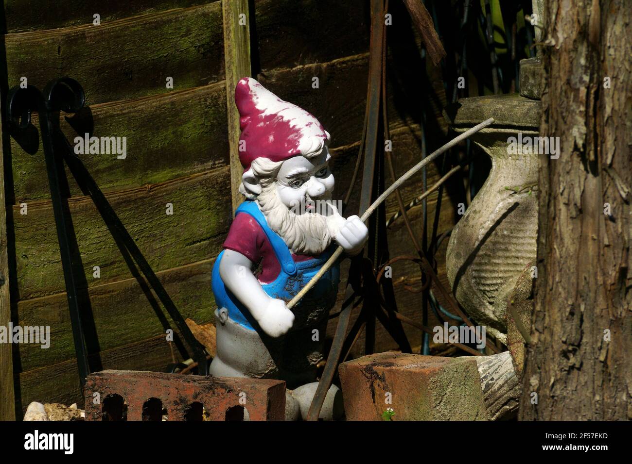 GNOME FISHING IN THE GARDEN Stock Photo