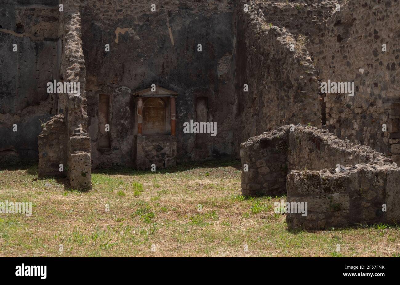 NAPLES, ITALY- JUNE, 13, 2019: a view of the ruins of a house in the ancient roman city of pompeii with its family shrine Stock Photo