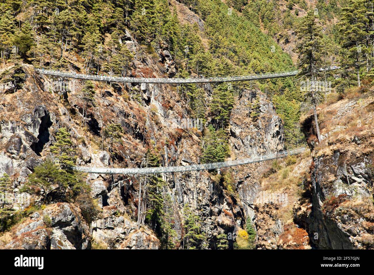 Two rope hanging suspension bridges in Nepal Himalayas under Namche Bazar above Dudh Koshi Nadi river, Mount Everest base camp trek Stock Photo