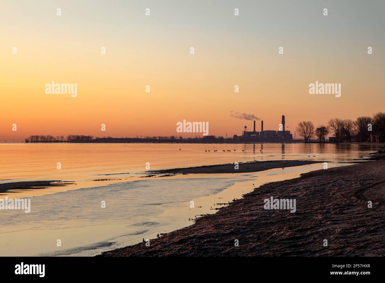 Sunrise over Saginaw bay, with Coal-fired energy plant, early spring, MI, USA, by James D Coppinger/Dembinsky Photo Assoc Stock Photo