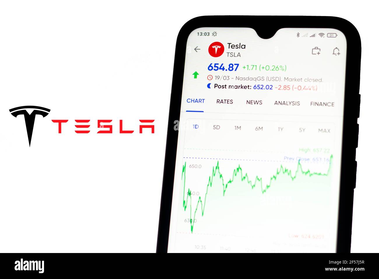 Brazil. 24th Mar, 2021. In this photo illustration the stock market information of Tesla seen displayed on a smartphone with the Tesla logo in the background. (Photo by Rafael Henrique/SOPA Images/Sipa USA) Credit: Sipa USA/Alamy Live News Stock Photo