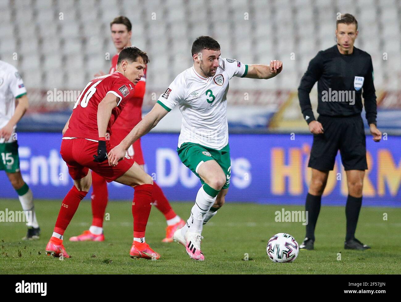 Serbia's Sasa Lukic (left) and Republic of Ireland's Enda Stevens in action during the 2022 FIFA World Cup Qualifying match at the Rajko Mitic Stadium in Belgrade, Serbia. Picture date: Wednesday March 24, 2021. Stock Photo