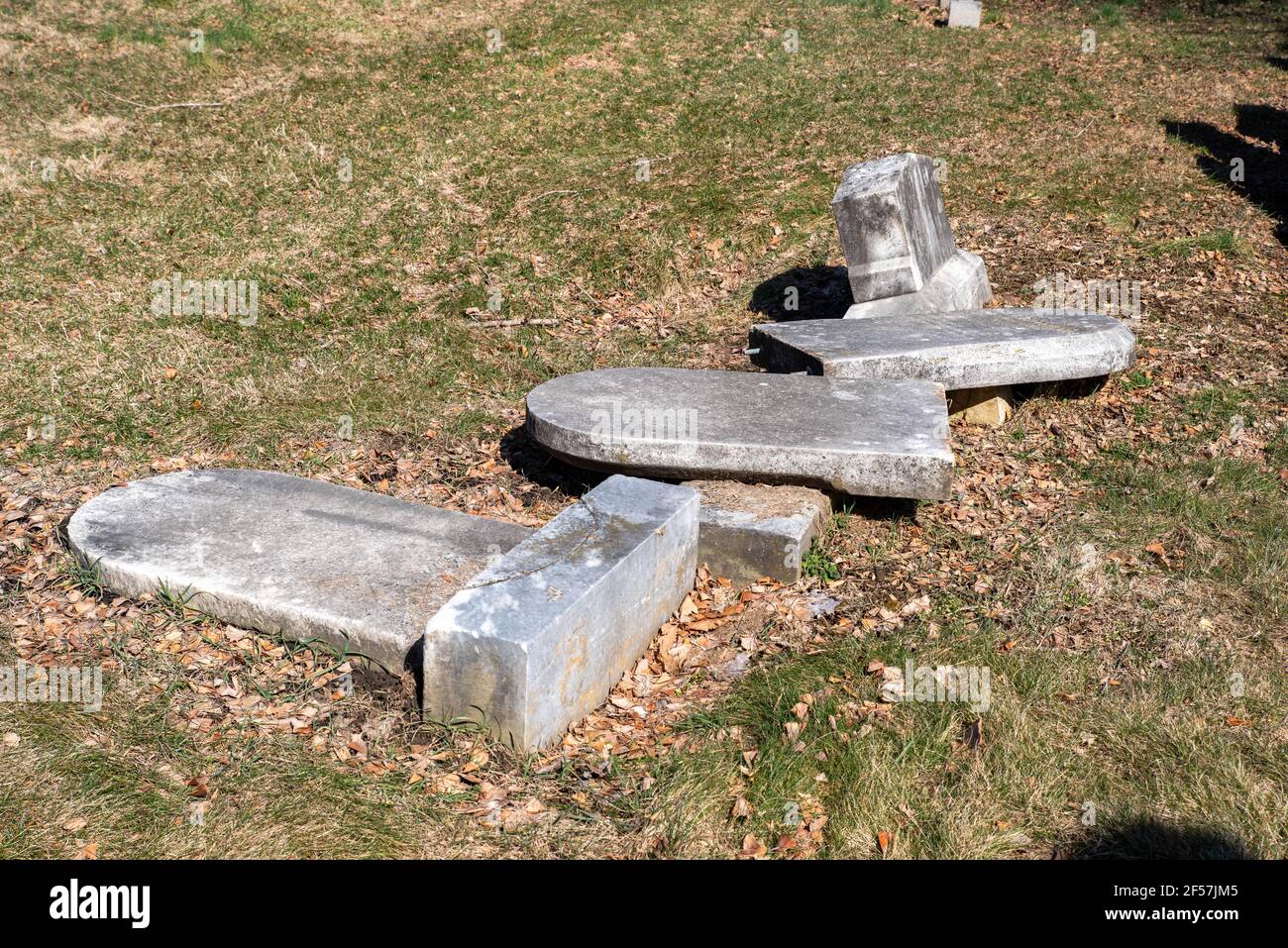 Toppled fallen cemetery tombstones grave markers Stock Photo