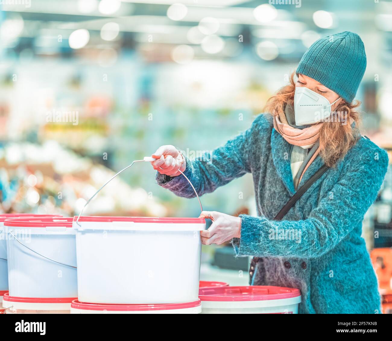 buying paint colors by young woman in the store Stock Photo Alamy
