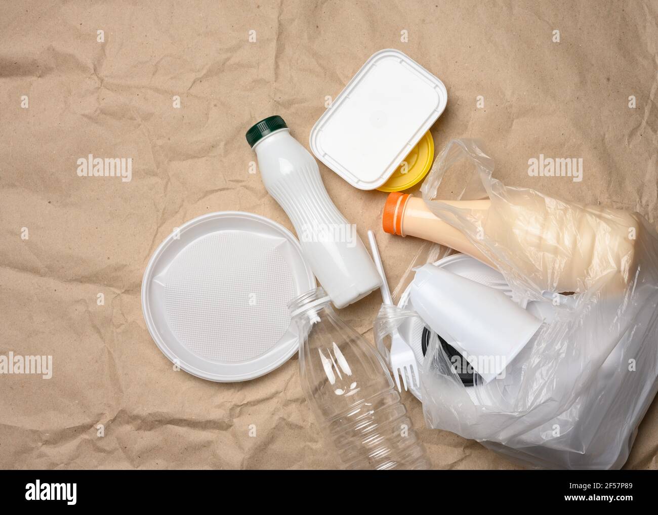 plastic waste from life on the background of brown kraft paper