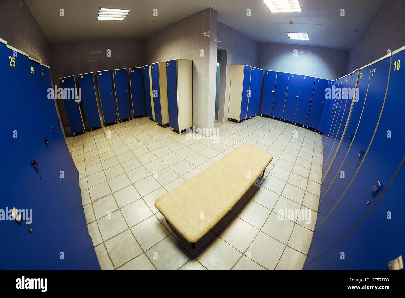 lockers in the gym locker room. bench in front of the shower. a place for athletes to change clothes after a competition and play sports Stock Photo