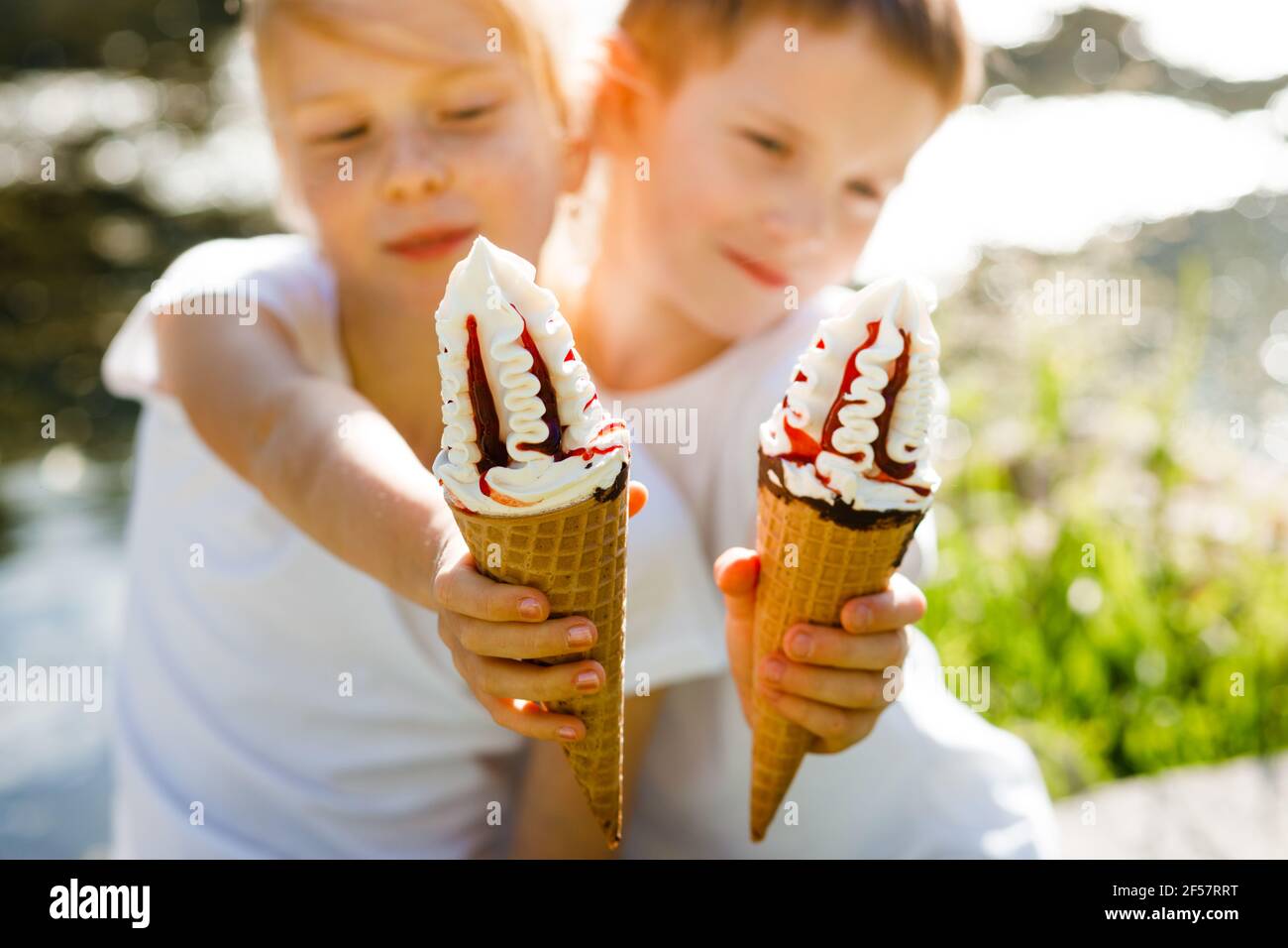 Children eat ice cream in the park Stock Photo Alamy