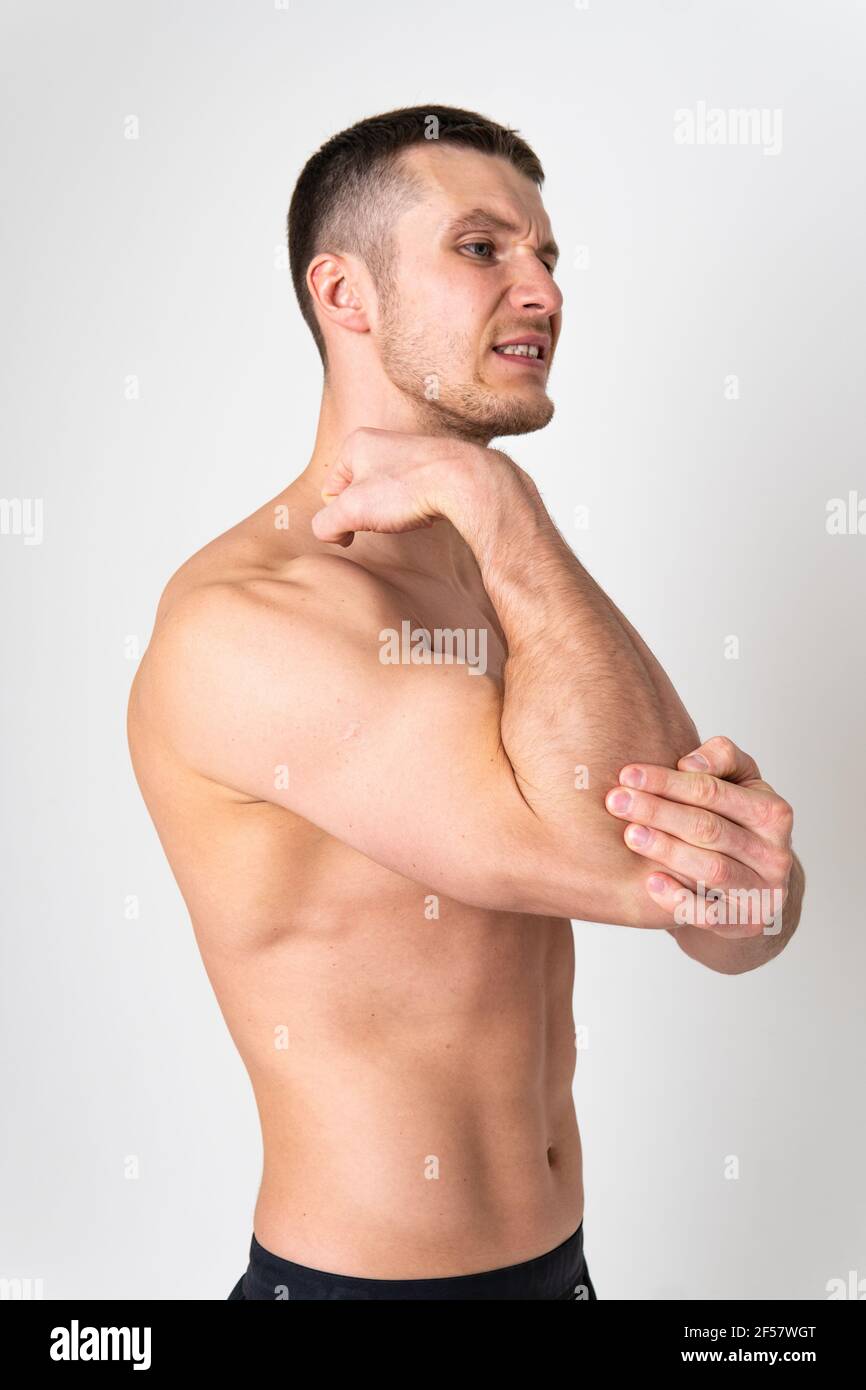 The elbow of the joint muscle in the male white background pain hurt