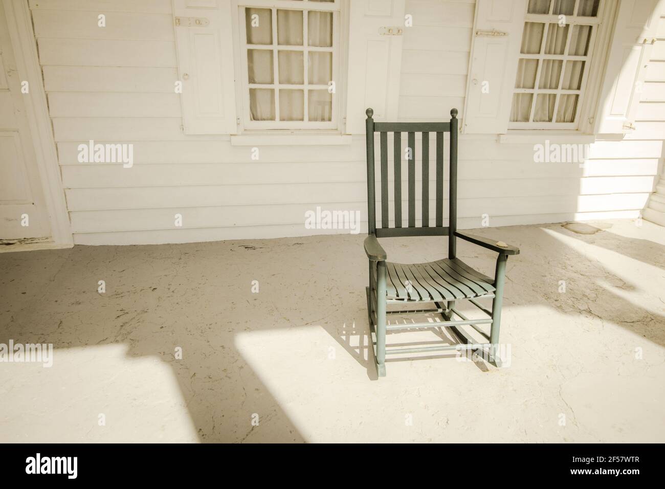 Single empty rocking chair on porch with copy space. Stock Photo