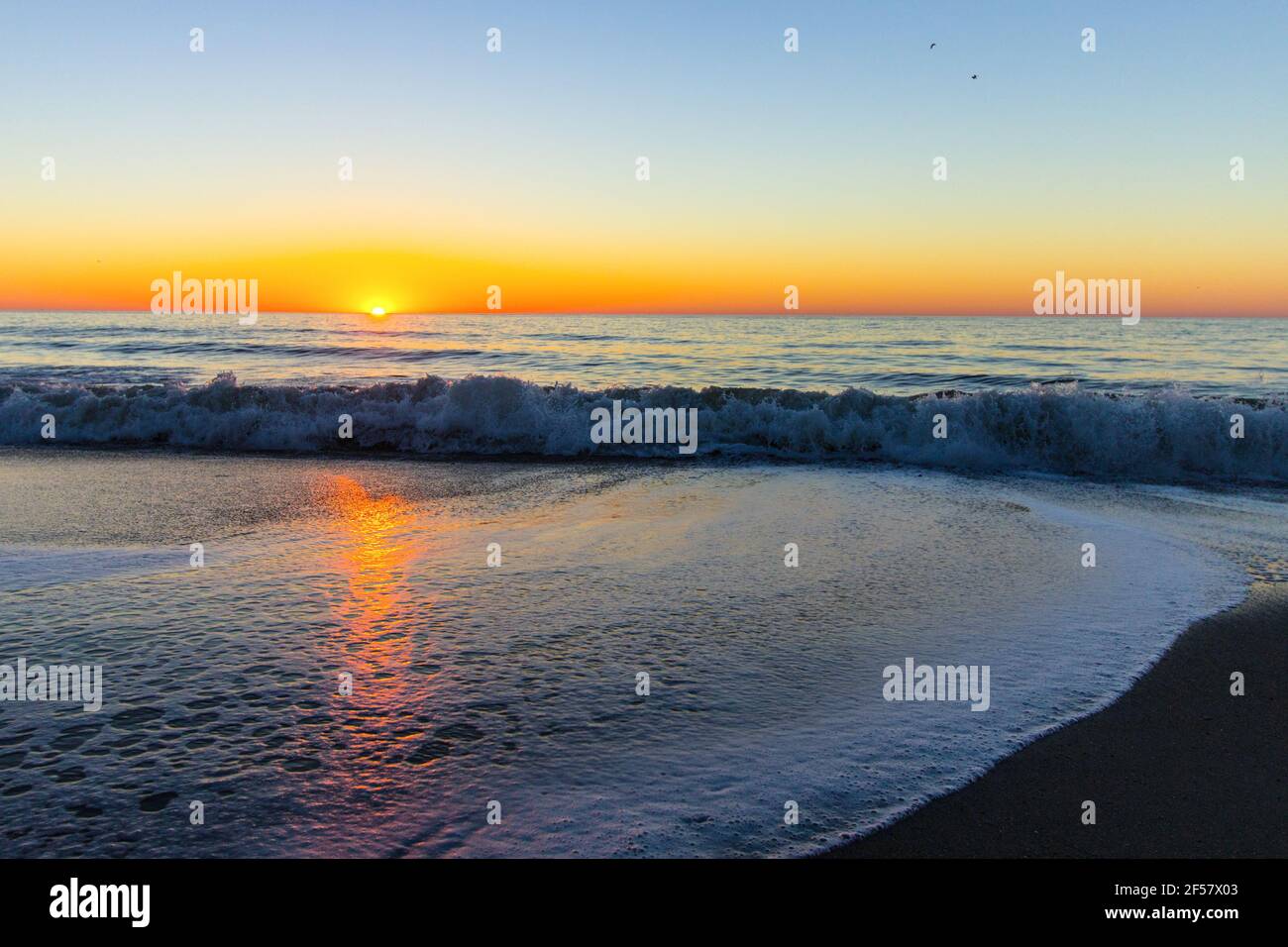 Myrtle Beach oceanfront sunrise with waves on the beach. Stock Photo