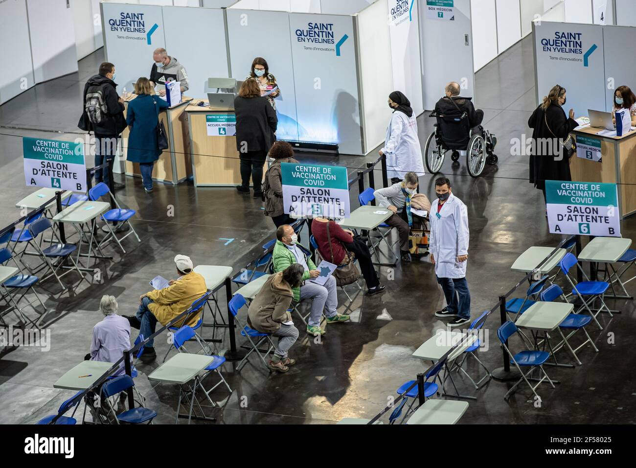 (210324) -- PARIS, March 24, 2021 (Xinhua) -- People wait in a COVID-19 vaccination center at the National Velodrome de Saint-Quentin-en-Yvelines in Saint-Quentin-en-Yvelines, France, on March 24, 2021. French President Emmanuel Macron on Tuesday stressed the importance of vaccination as the country's COVID-19 cases kept rising. Since the start of the vaccination campaign in France, nearly 6.6 million people, or about 12.6 percent of the adult population, have received at least one injection, and over 2.5 million have received two injections, according to the Health Ministry. (Photo by Aurelie Stock Photo