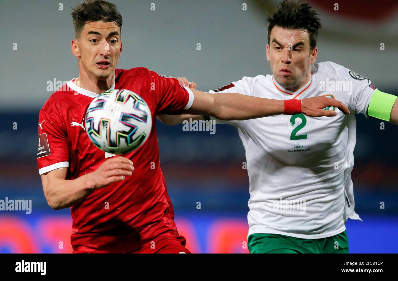 Belgrade. 24th Mar, 2021. Serbia's Filip Djuricic (L) fights for the ball with Ireland's Seamus Coleman during the FIFA World Cup 2022 qualification football match between Serbia and Ireland in Belgrade, Serbia on March 24, 2021. Credit: Predrag Milosavljevic/Xinhua/Alamy Live News Stock Photo