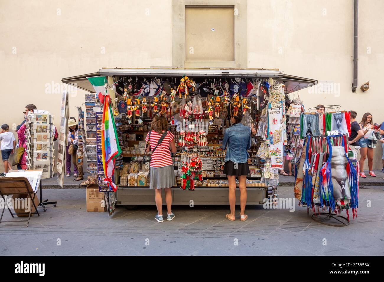Two Women Looking at Souvenir Stall in Florence, Italy Stock Photo