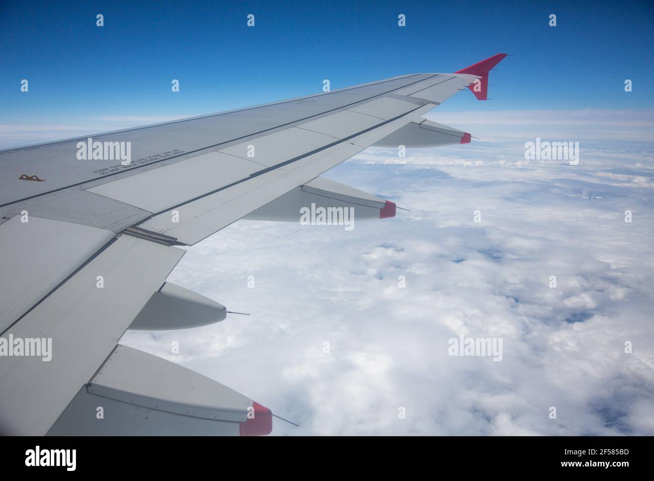 Of The Wing Of A Jet Aircraft Above The Clouds, Horizontal Stock Photo