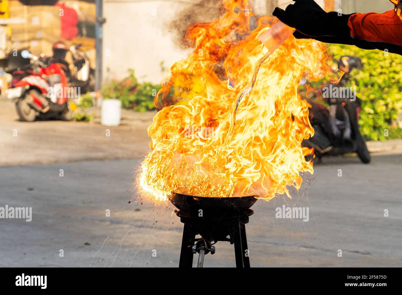 Firefighters teach or demonstrate the fire by pouring water into a very