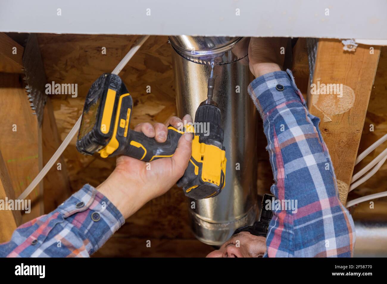 Construction home the install of HVAC vent hose duct pipes in ceiling