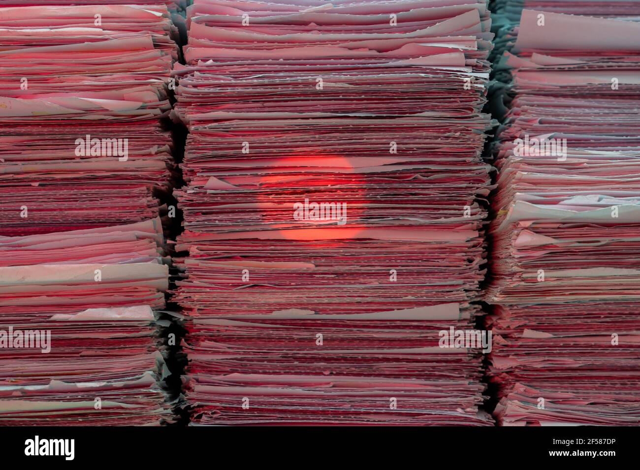 Stack of documents on desktop in office and red dot beam of barcode ...