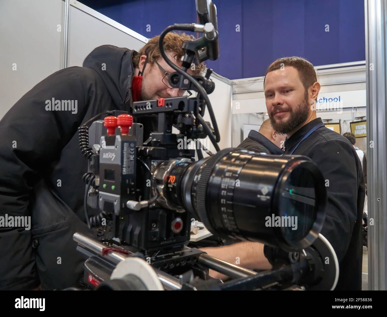 Moscow, Russia. 24th Mar, 2021. Guests looking at a movie camera during the  17th International Exhibition of Equipment, Services and New Technologies  for Film and Television Production CPS 2021 in Moscow.The largest