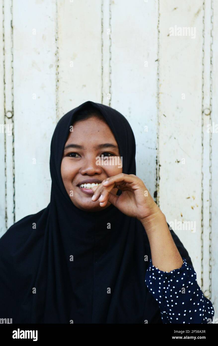 Portrait of a smiling Indonesian woman taken at the market in Banyuwangi, East Java, Indonesia. Stock Photo