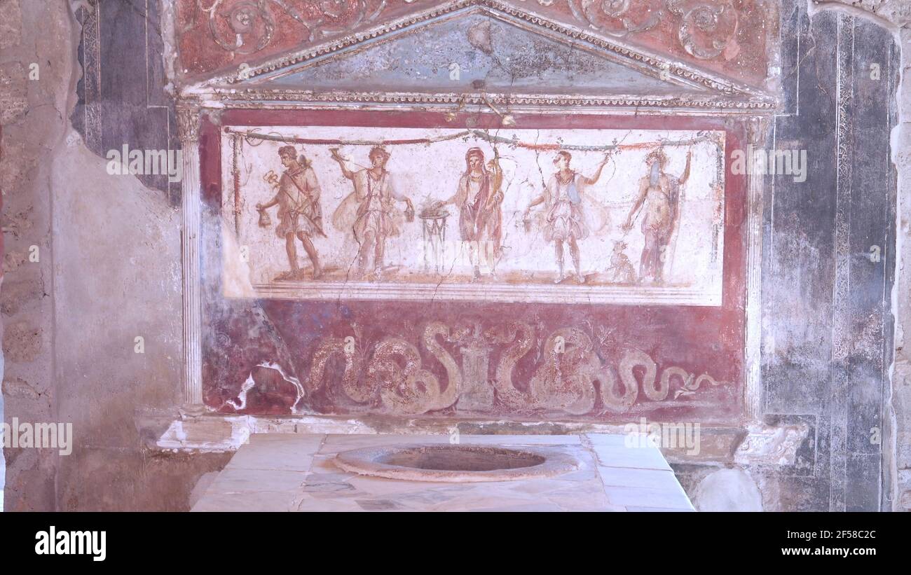 NAPLES, ITALY- JUNE, 13, 2019: a painted lararium of five figures in the thermopolium of vetutius placidus at pompeii Stock Photo
