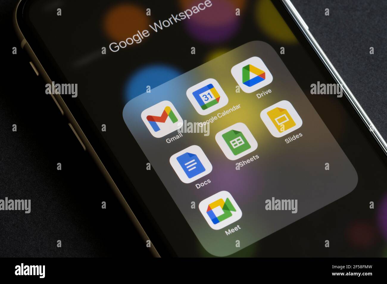 The core apps included in Google Workspace (formerly G Suite) are seen on an iPhone - Gmail, Calendar, Drive, Docs, Sheets, Slides, and Meet. Stock Photo