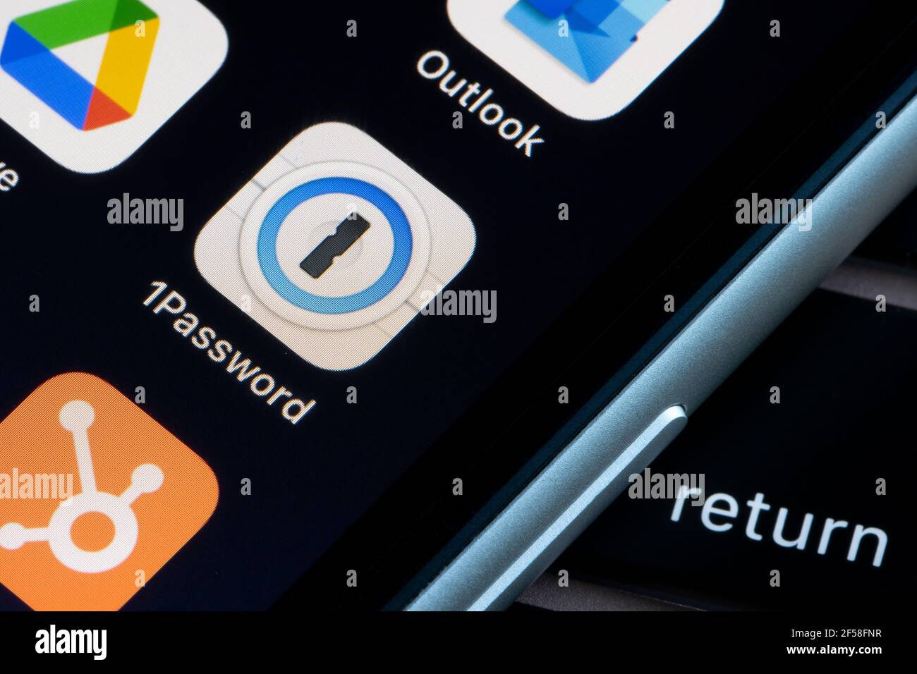 1Password mobile app icon is seen on an iPhone. 1Password is a password manager developed by AgileBits, Inc. Stock Photo