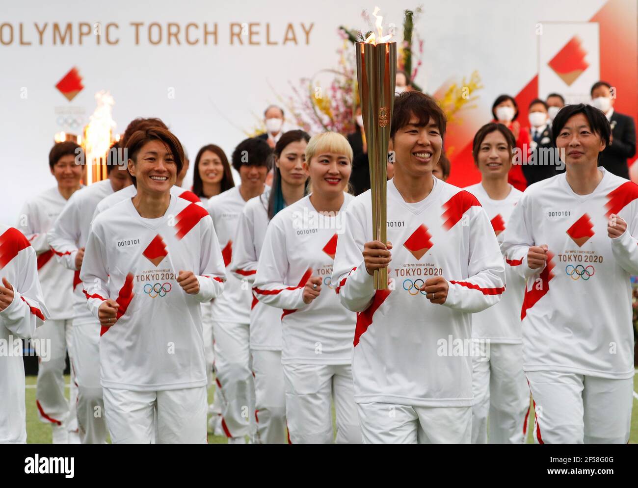 FUKUSHIMA, March 25, 2021  Iwashimizu Azusa (front) and other former members of 'Nadeshiko Japan', the Japan women's National Football Team, run as torchbearers in the first leg of the torch relay for Tokyo Olympic Games at J-Village National Training Center in Futaba, Fukushima of Japan, on March 25, 2021. (Kim Kyung-Hoon/Pool via Xinhua) Stock Photo