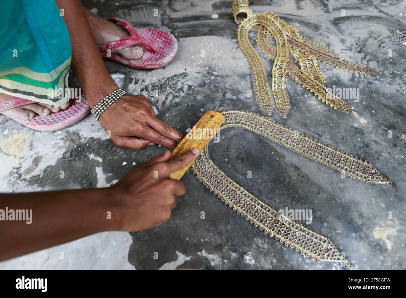 Workers make and sorting out copper and silver jewellery at Bhakurta