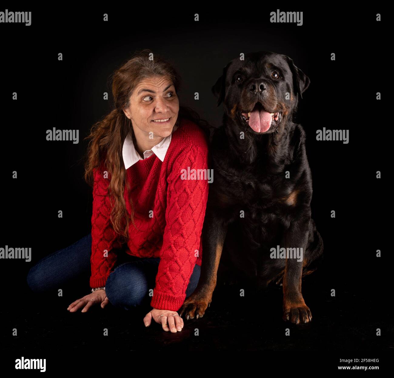 Three Rottweilers Woman purebred rottweiler and woman in front of black background Stock Photo ...