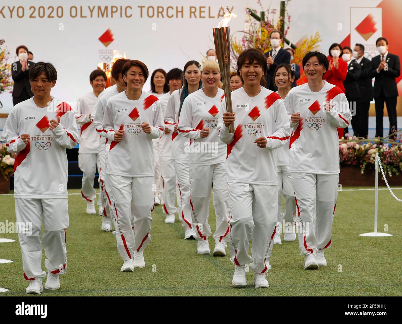 FUKUSHIMA, March 25, 2021  Former members of 'Nadeshiko Japan,' the Japan women's National Football Team, run as torchbearers on the first day of the Tokyo 2020 Olympic torch relay at J-Village National Training Center in Futaba, Fukushima of Japan, on March 25, 2021. (Kim Kyung-Hoon/Pool via Xinhua) Stock Photo