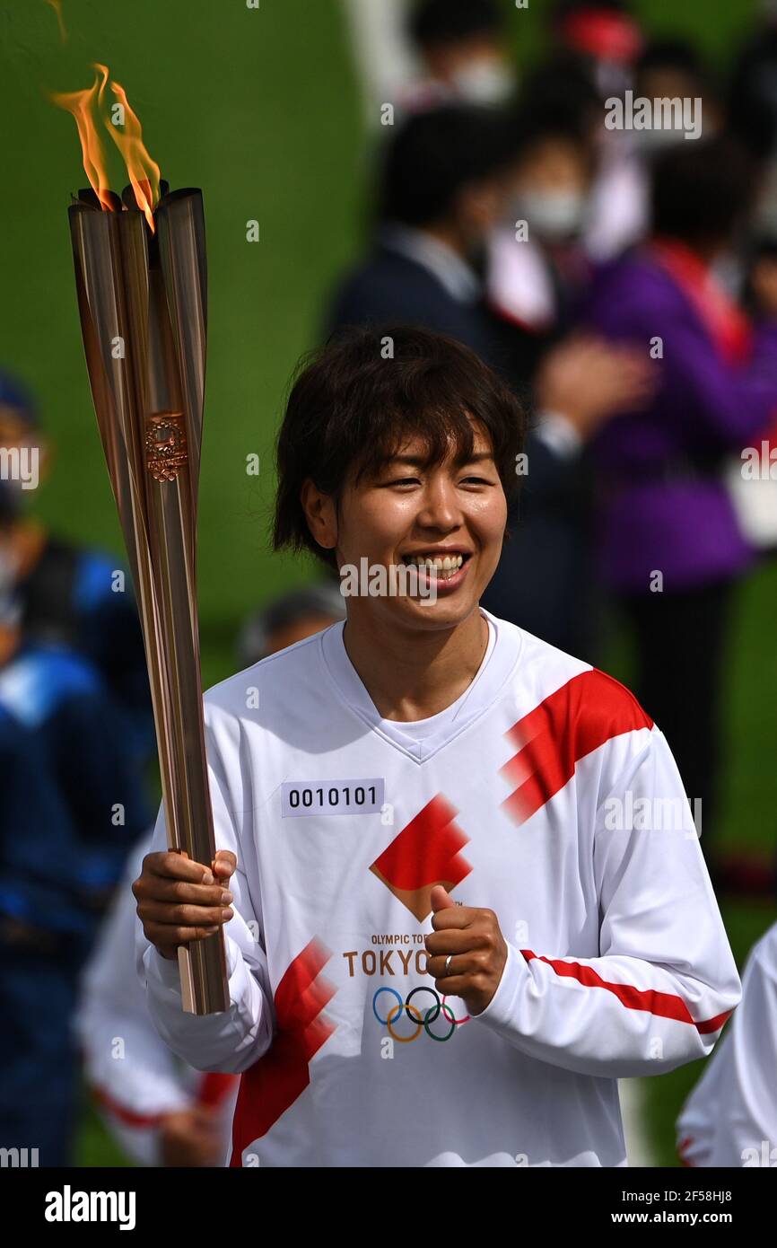 FUKUSHIMA, March 25, 2021  Iwashimizu Azusa, former member of 'Nadeshiko Japan', the Japan women's National Football Team, runs as one of torchbearers on the first day of the Tokyo 2020 Olympic torch relay in Futaba, Fukushima of Japan, on March 25, 2021. (Philip Fong/POOL via Xinhua) Stock Photo