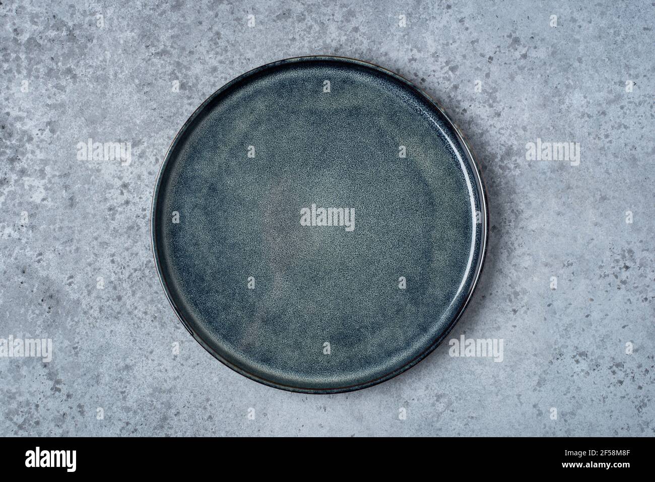 An empty plate on a gray table. Stock Photo