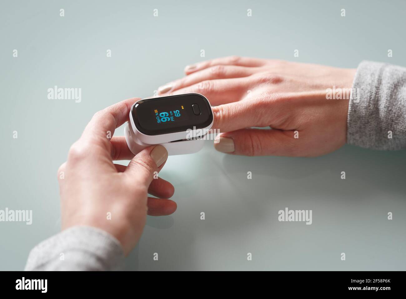 Close up view of female patient hands measuring oxygen saturation and