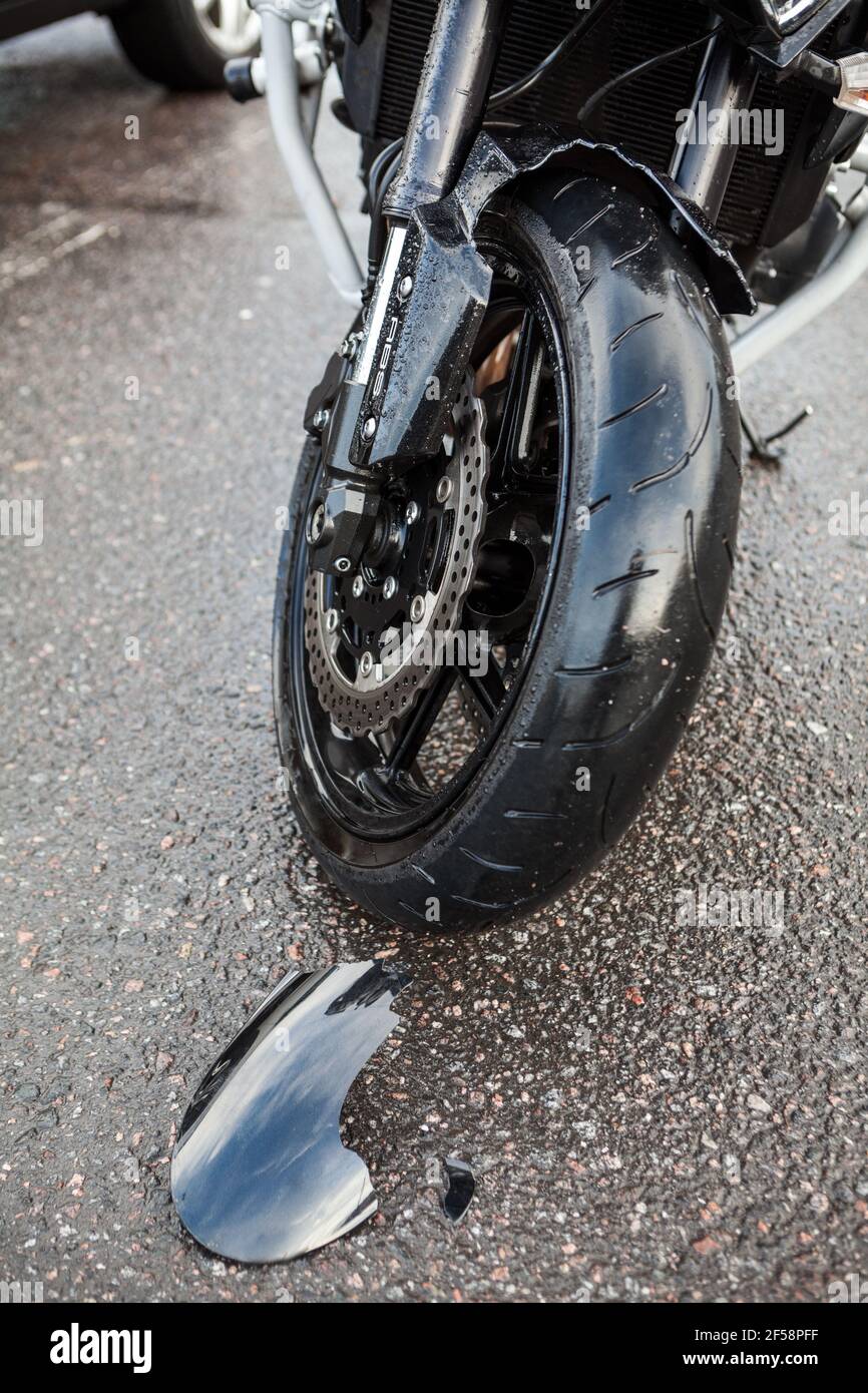 Broken off a piece of black plastic fender of motorcycle lying on