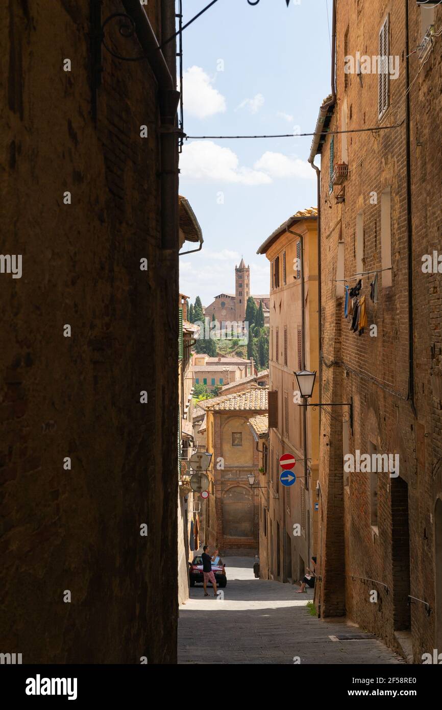 Narrow Alley With Old Buildings In Medieval Town of Siena, Tuscany  Stock Photo