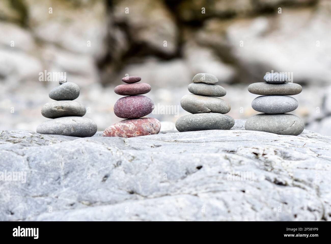 A background of pebbles by the ocean on the beach, a symbol of peace and relaxation. Stock Photo