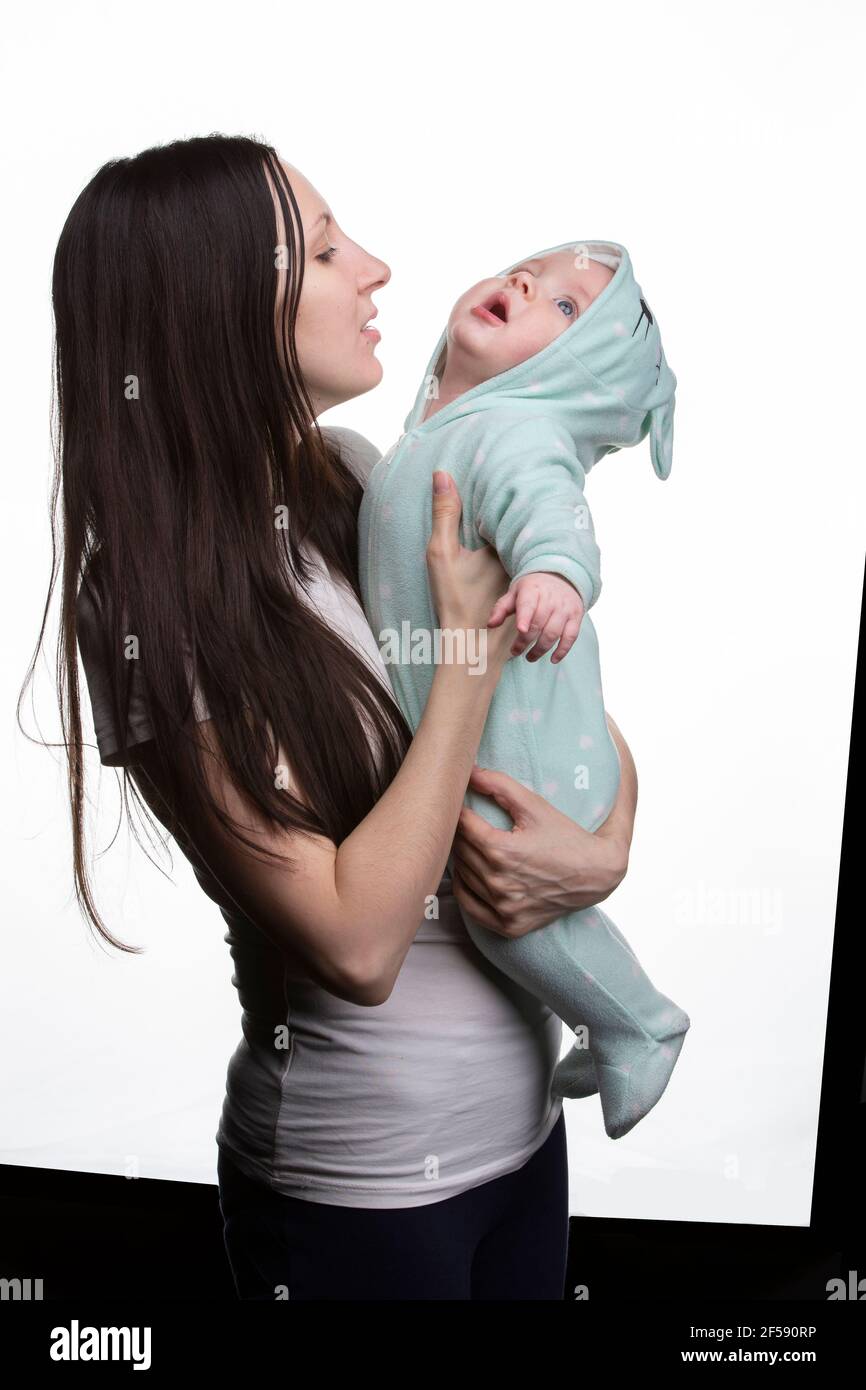 Portrait of a beautiful mother and little son on a light background. Stock Photo