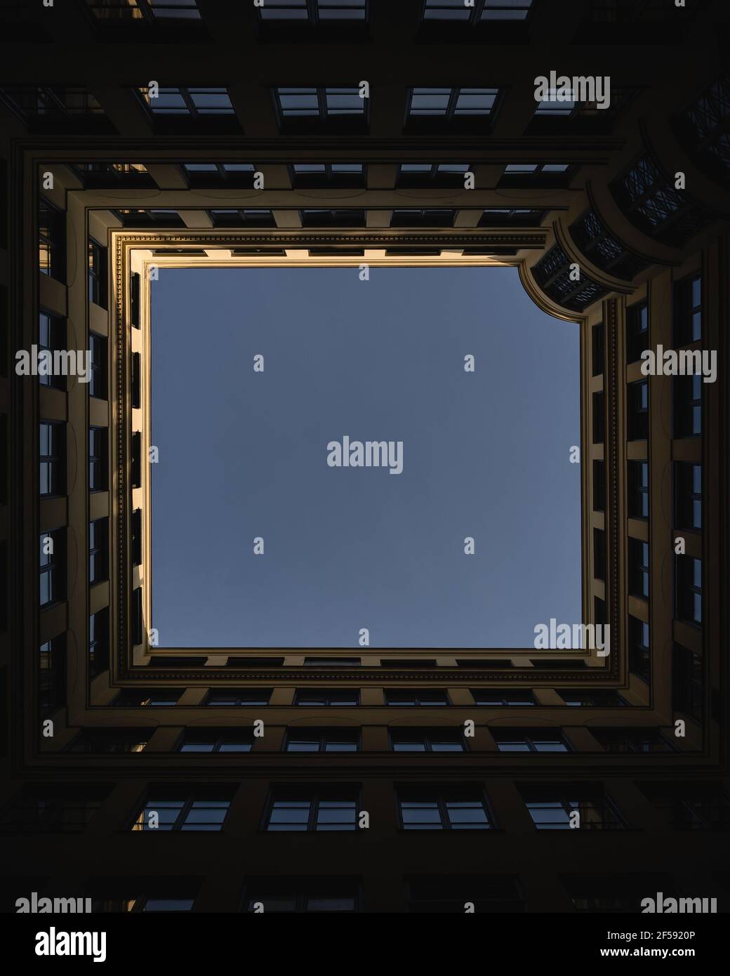 Vertical low angle shot of a modern building under blue Stock Photo - Alamy