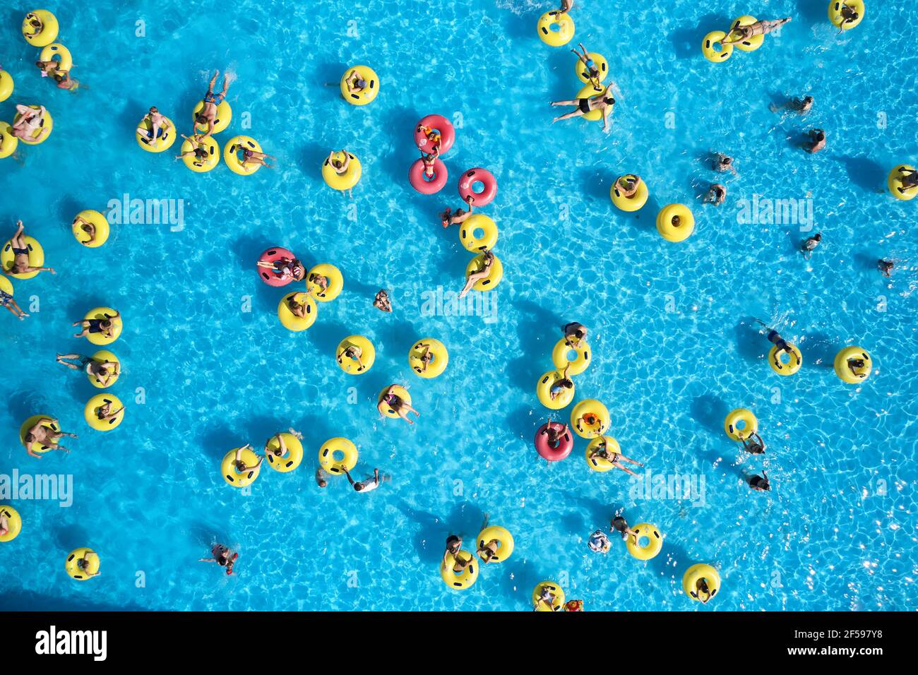 Water park background. Top view young people relax in swimming pool