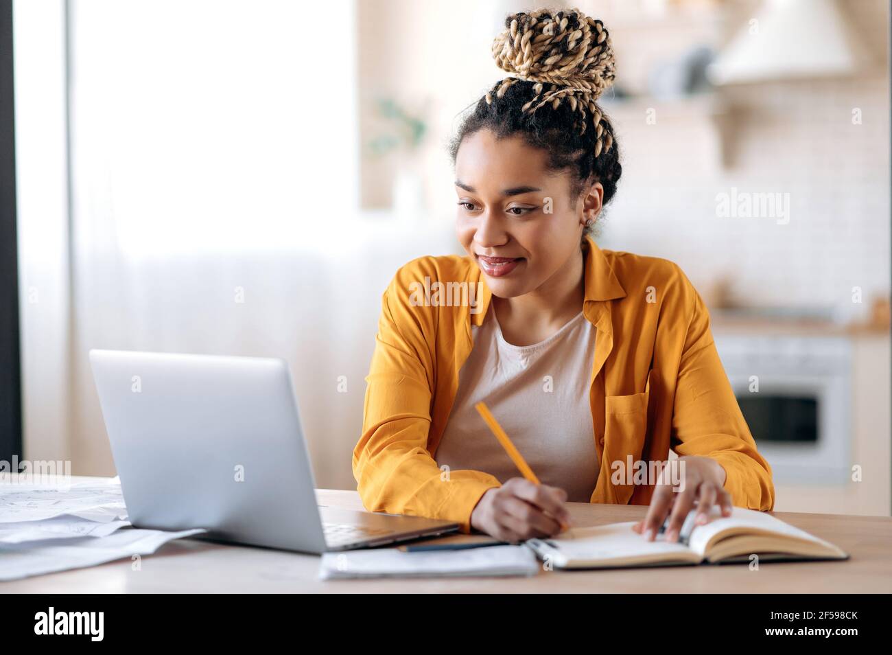 Focused cute stylish african american female student with afro ...