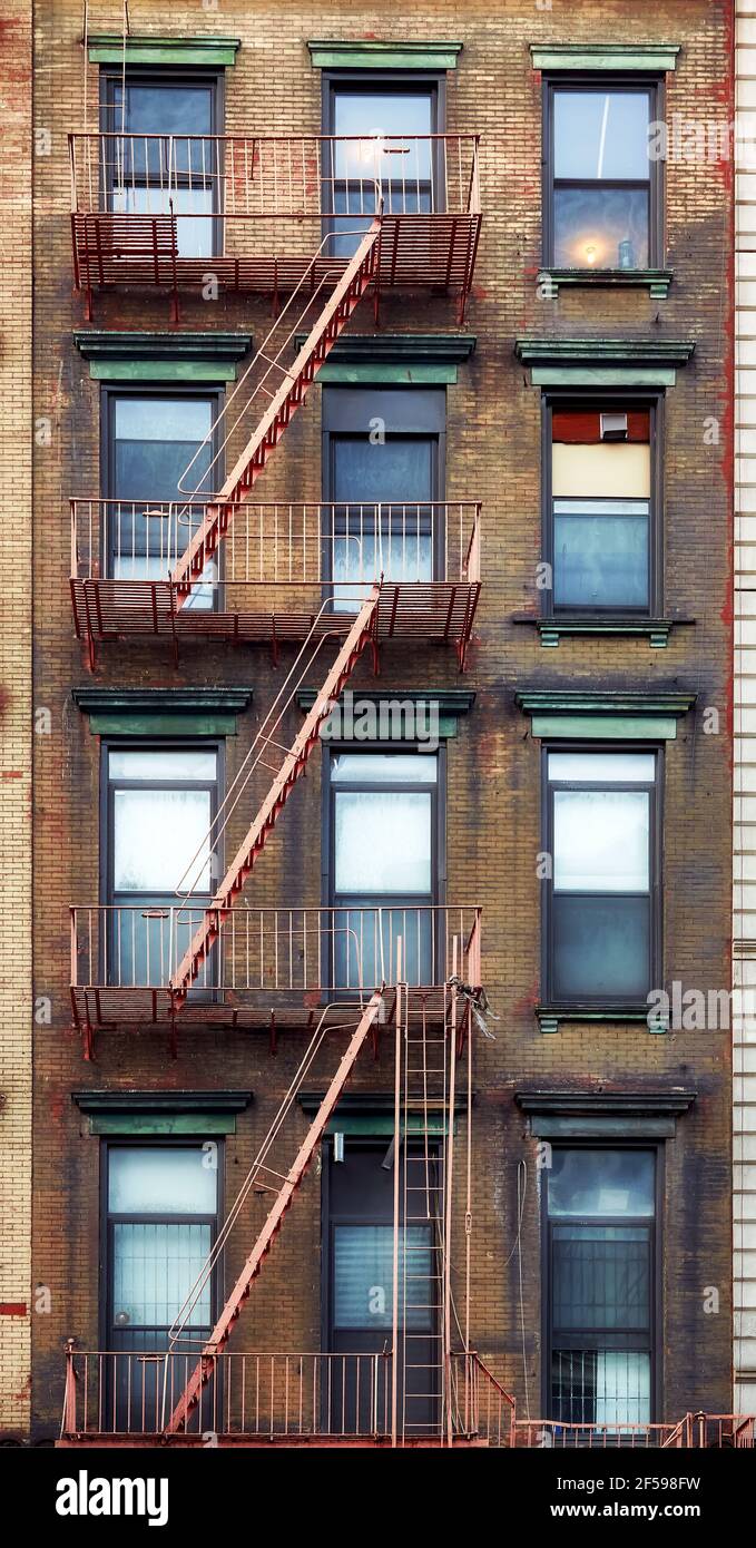 Old townhouse building with iron fire escape, New York City, USA. Stock Photo