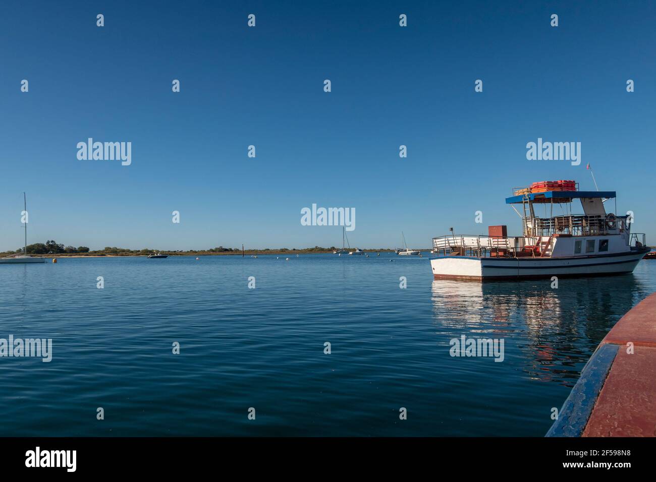 Tourist boat moored on the Gilao River near Tavira, Algarve, Portugal Stock Photo