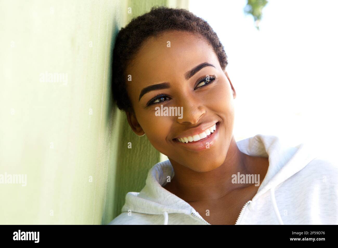 Close up portrait of beautiful young black woman smiling outside Stock ...