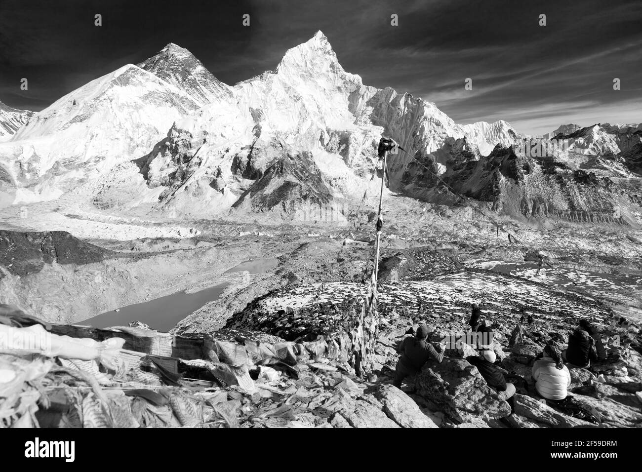 View of mount Everest, Lhotse and Nuptse with prayer flags and tourists from Kala Patthar black and white, Khumbu valley, Nepal Himalayas mountains Stock Photo
