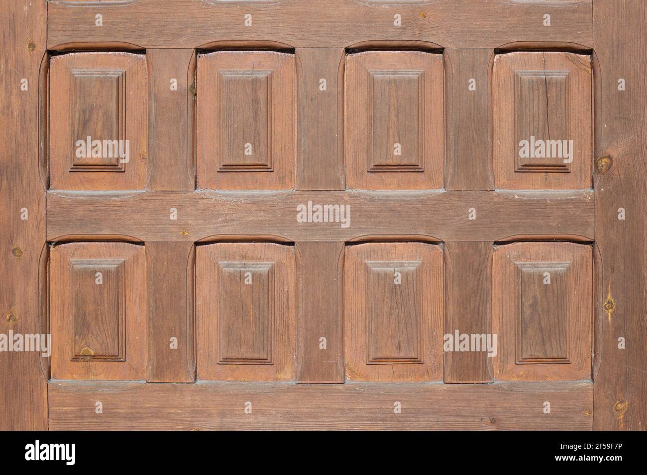 A wooden plank with 8 carved rectangles. middle plan of an antique european style door. Stock Photo