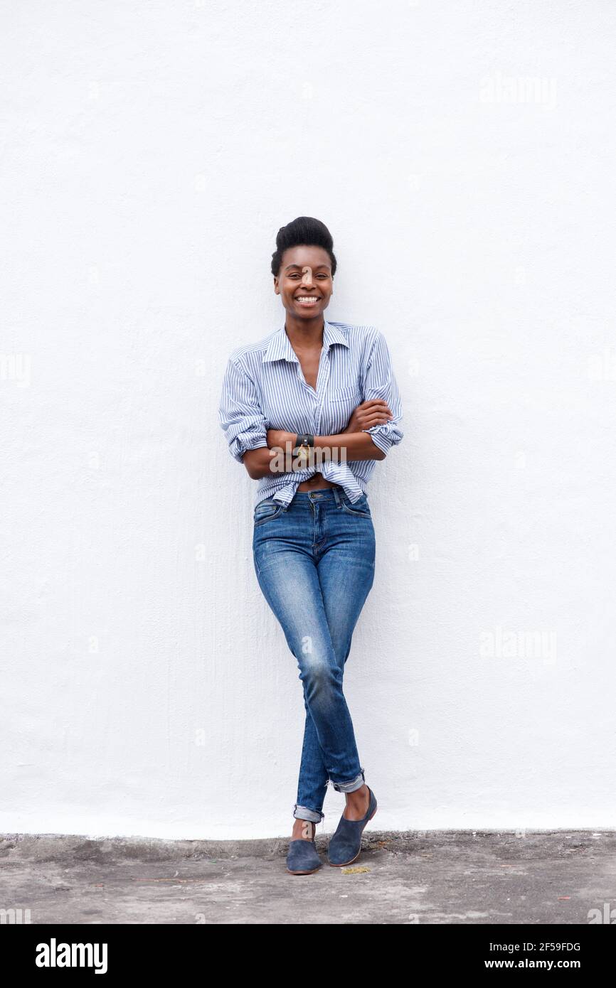 Full length portrait of african american woman smiling against white ...