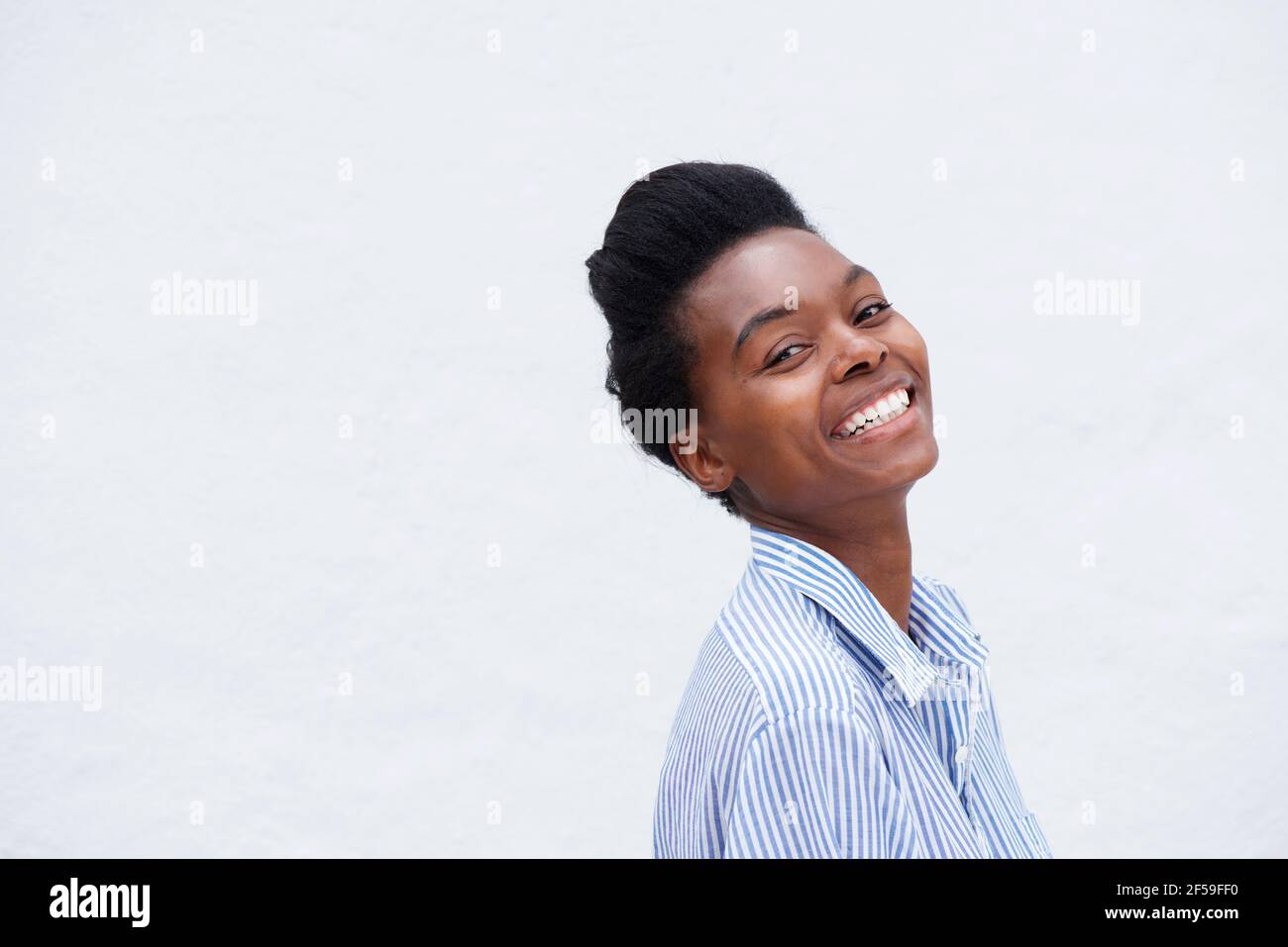 Portrait of young african woman laughing against white background Stock ...