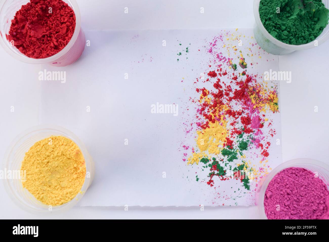 Holi colours powder scattered on white background with colours ...